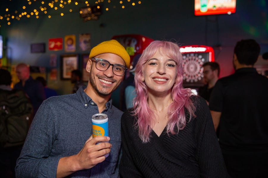 Two smiling friends posing together at a Joybreak night out in Orlando